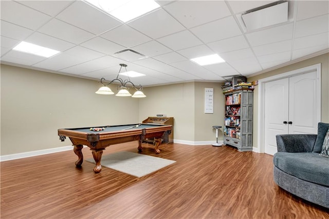 game room with billiards, wood finished floors, a paneled ceiling, and baseboards