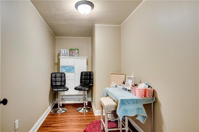 miscellaneous room featuring ornamental molding, baseboards, and wood finished floors