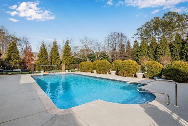 view of swimming pool with a patio area, fence, and a fenced in pool