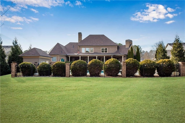 exterior space featuring a lawn, fence, and a sunroom