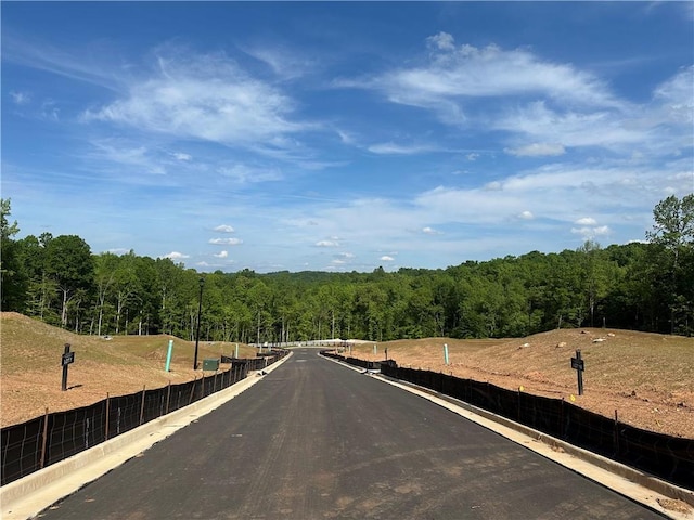 view of road featuring a forest view