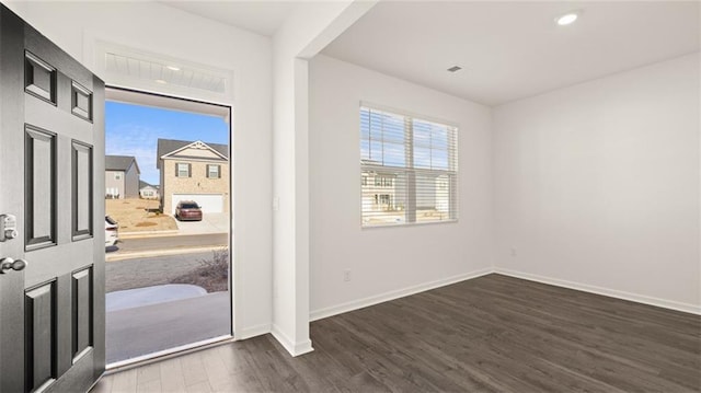 foyer entrance with baseboards, wood finished floors, and recessed lighting