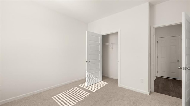 unfurnished bedroom with baseboards, a closet, and carpet