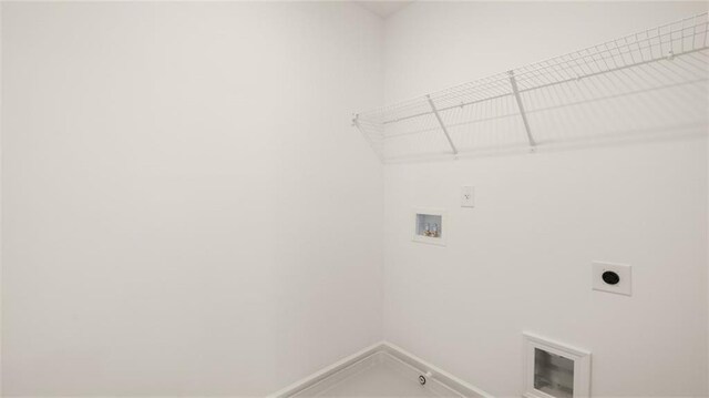 clothes washing area with hookup for an electric dryer, washer hookup, baseboards, laundry area, and hookup for a gas dryer
