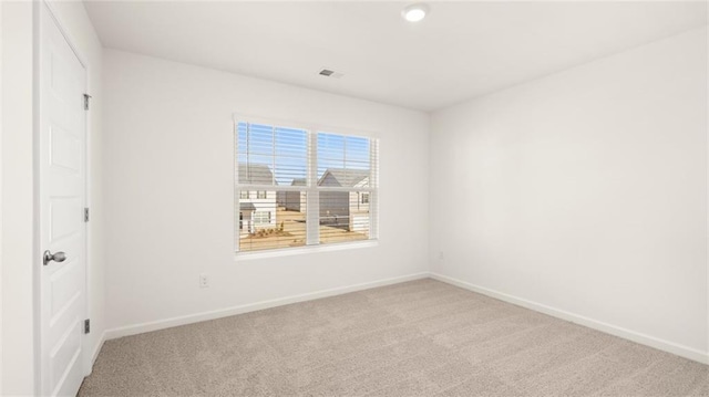 unfurnished room featuring baseboards and carpet flooring