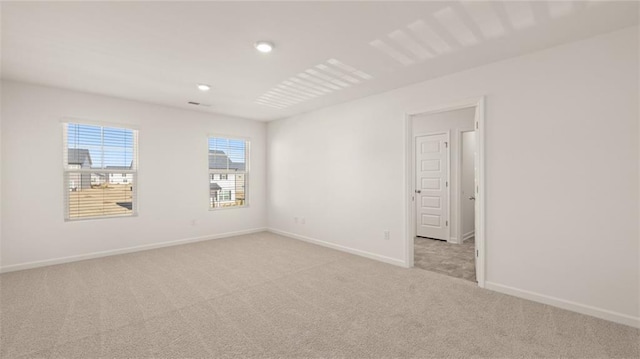 empty room with light carpet and baseboards