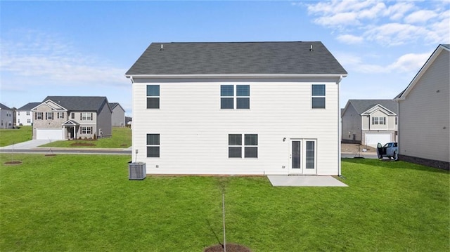 back of house with a residential view, a patio area, and a yard