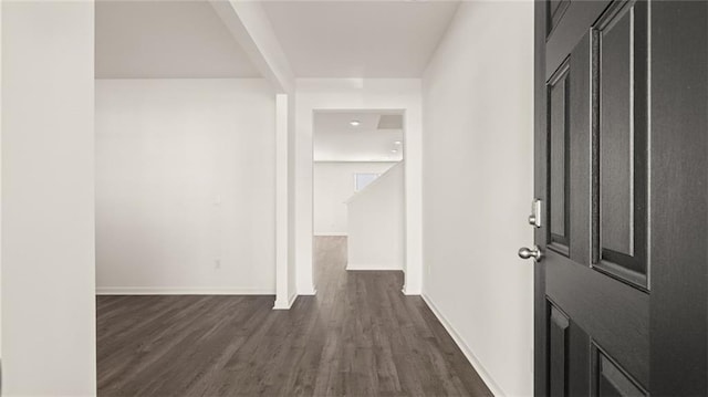 entryway with dark wood-style flooring and baseboards