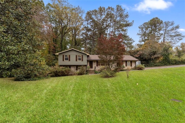 tri-level home with a front yard