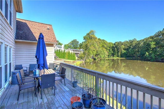 wooden deck featuring a water view