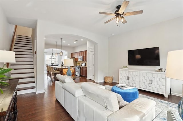 living room featuring dark hardwood / wood-style floors and ceiling fan