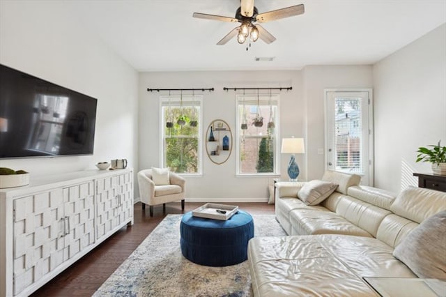 living room with plenty of natural light, dark hardwood / wood-style floors, and ceiling fan