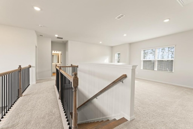 hall featuring light carpet, recessed lighting, visible vents, and an upstairs landing