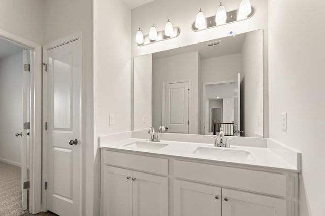 bathroom with double vanity, a sink, and visible vents