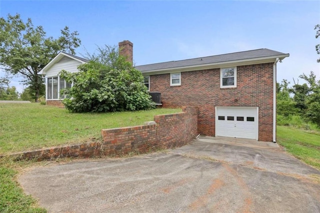 view of property exterior with a yard, central AC unit, and a garage