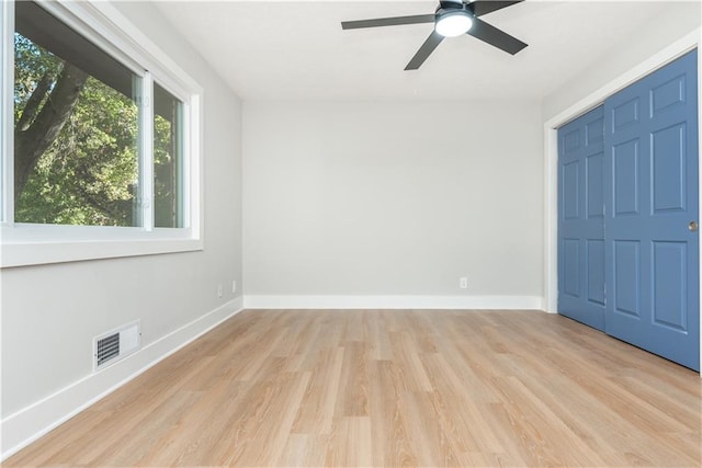 unfurnished bedroom featuring ceiling fan, a closet, and light hardwood / wood-style floors