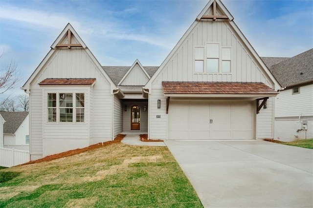 view of front of house with concrete driveway, a front lawn, board and batten siding, and an attached garage
