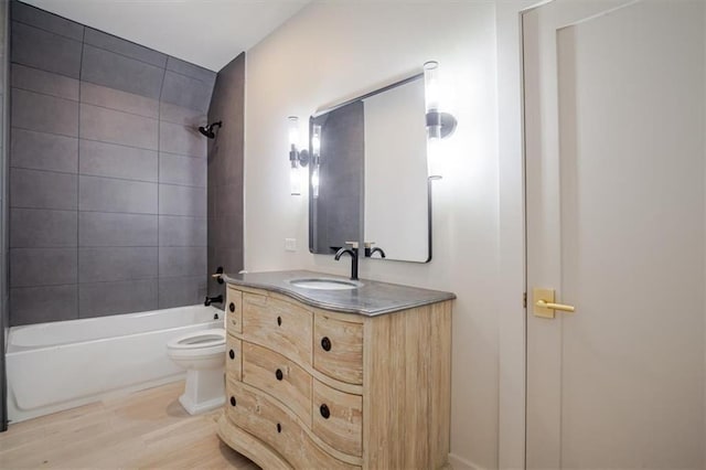 full bathroom featuring vanity, shower / tub combination, toilet, and wood finished floors