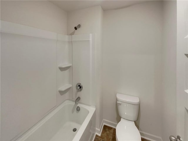 bathroom with baseboards, shower / bathing tub combination, and toilet