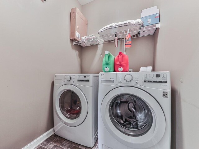 clothes washing area with separate washer and dryer