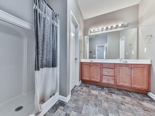 bathroom featuring vanity and a shower with shower curtain