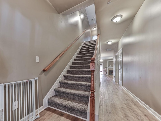 stairway with hardwood / wood-style flooring