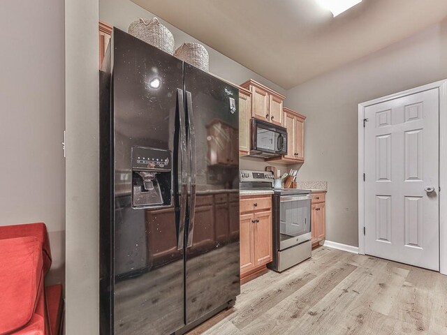 kitchen featuring light hardwood / wood-style flooring, black appliances, and light brown cabinetry