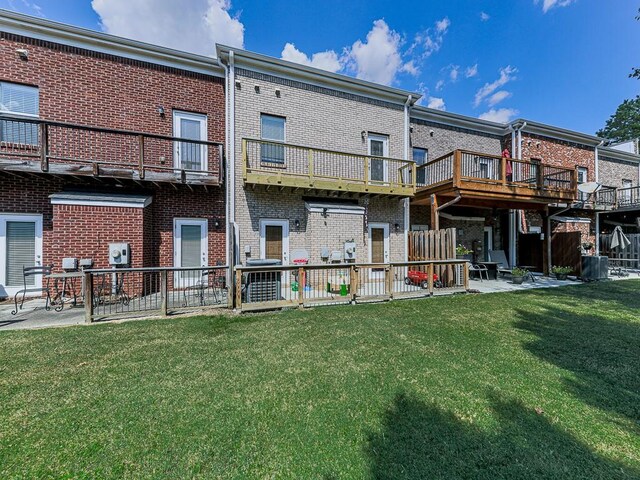 back of house featuring a yard, central air condition unit, and a patio area