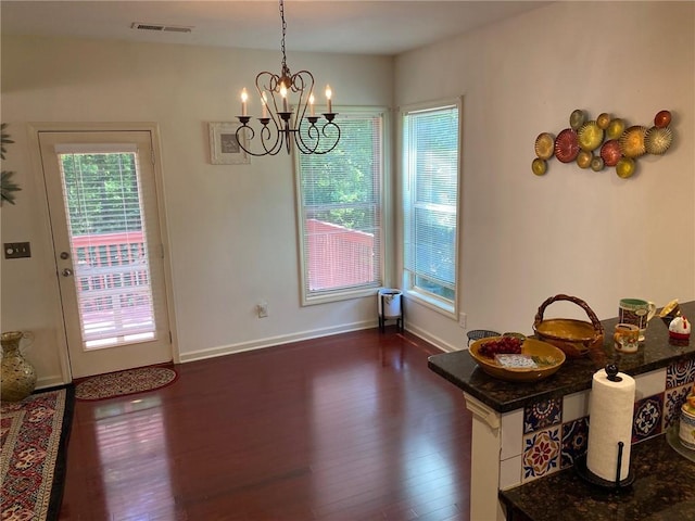 3692 Archgate Ct, Alpharetta, GA 30004 - dining area with dark wood finished floors, a chandelier, and baseboards