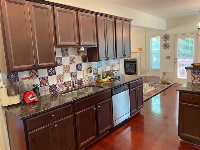 3692 Archgate Ct, Alpharetta, GA 30004 - kitchen with dishwasher, a sink, backsplash, dark wood-style floors, and dark stone countertops