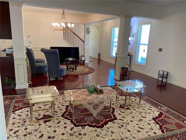 3692 Archgate Ct, Alpharetta, GA 30004 - living room featuring ornate columns, ornamental molding, a chandelier, wood finished floors, and stairs