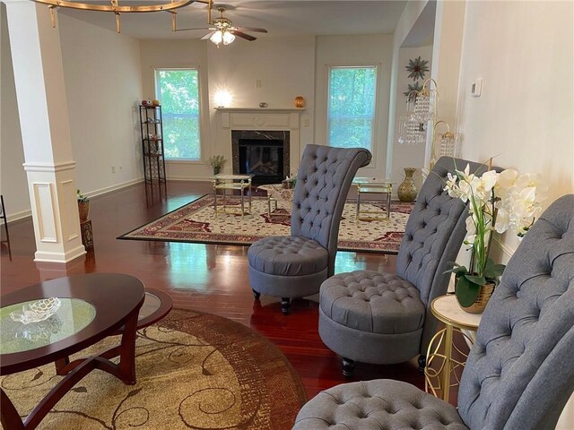 3692 Archgate Ct, Alpharetta, GA 30004 - living room featuring wood finished floors, a ceiling fan, a fireplace, ornate columns, and baseboards