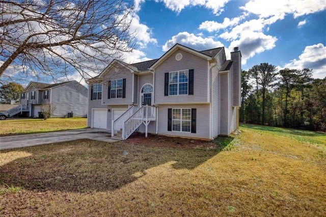 bi-level home featuring a garage and a front yard