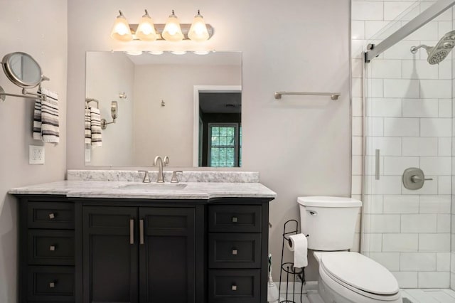 bathroom with walk in shower, vanity, and toilet