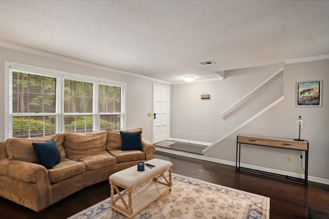 living room featuring a textured ceiling, dark hardwood / wood-style floors, and ornamental molding