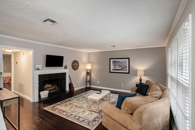 living room featuring dark hardwood / wood-style flooring, a textured ceiling, and crown molding