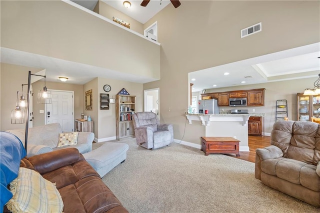 108 Lake Point Ct, Jefferson, GA 30549 - living room with light colored carpet, ceiling fan, and a high ceiling