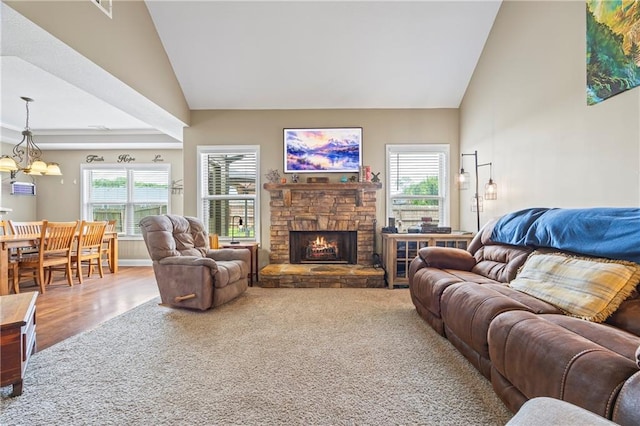 108 Lake Point Ct, Jefferson, GA 30549 - carpeted living room featuring a chandelier, high vaulted ceiling, a fireplace, and wood finished floors