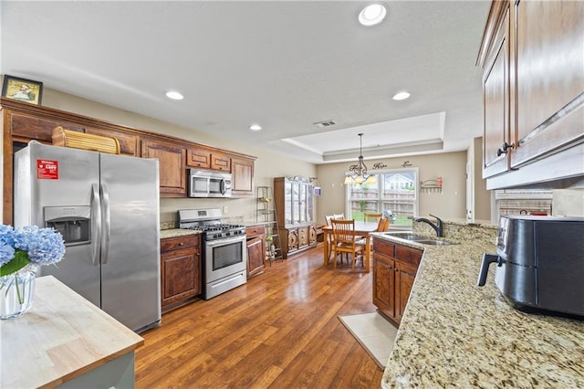 108 Lake Point Ct, Jefferson, GA 30549 - kitchen featuring appliances with stainless steel finishes, a raised ceiling, dark wood finished floors, recessed lighting, and a fireplace