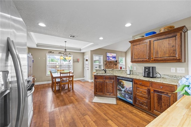 108 Lake Point Ct, Jefferson, GA 30549 - kitchen featuring dishwashing machine, freestanding refrigerator, dark wood-type flooring, a raised ceiling, and pendant lighting