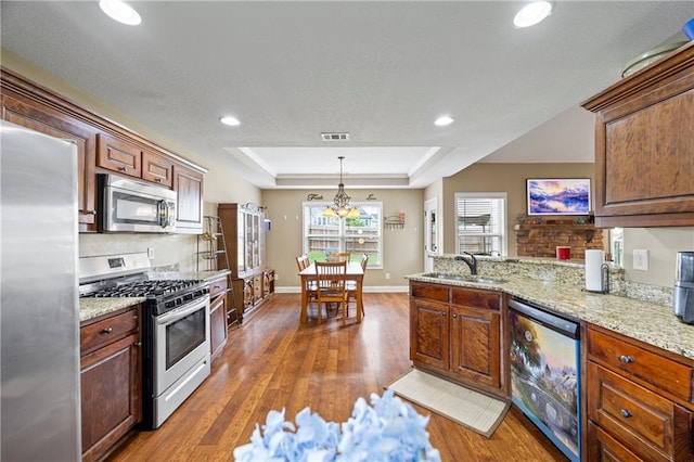 108 Lake Point Ct, Jefferson, GA 30549 - kitchen featuring stainless steel appliances, a raised ceiling, wood finished floors, a peninsula, and recessed lighting