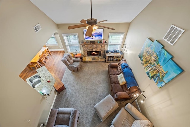 108 Lake Point Ct, Jefferson, GA 30549 - living area with ceiling fan, vaulted ceiling, a fireplace, and carpet floors