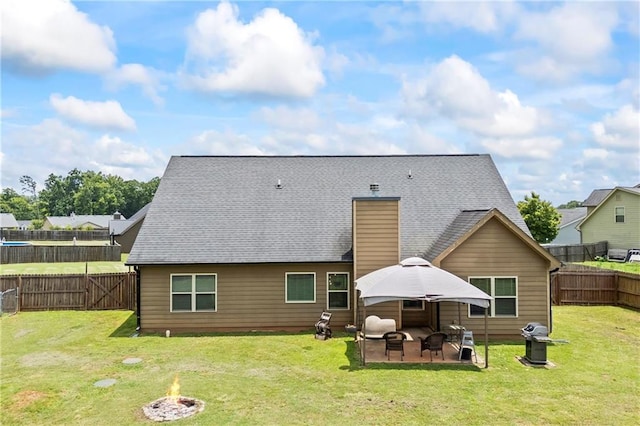 108 Lake Point Ct, Jefferson, GA 30549 - back of house with an outdoor fire pit, a patio area, a fenced backyard, and a shingled roof