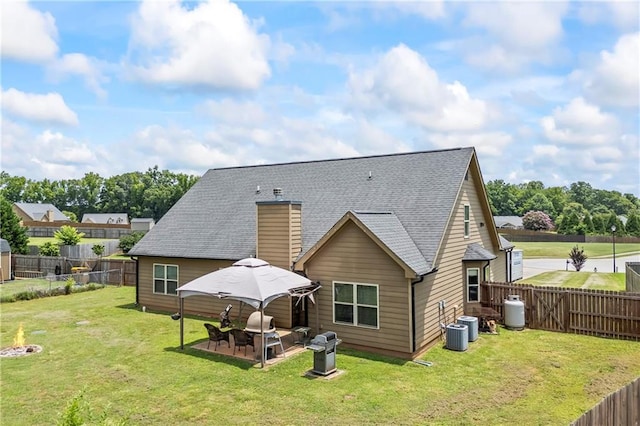 108 Lake Point Ct, Jefferson, GA 30549 - back of property with a fenced backyard, roof with shingles, a chimney, and a patio area