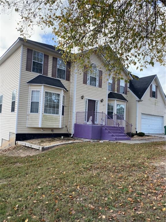 view of front of property featuring a garage and a front lawn