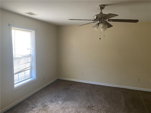 carpeted empty room with a healthy amount of sunlight and ceiling fan