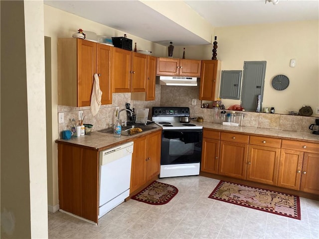 kitchen featuring sink, range with electric stovetop, white dishwasher, electric panel, and decorative backsplash