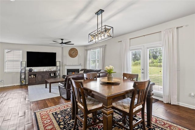 8553 Braylen Manor Dr, Douglasville, GA 30134 - dining room with dark wood-type flooring, ceiling fan, and a glass covered fireplace