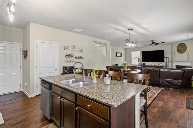 8553 Braylen Manor Dr, Douglasville, GA 30134 - kitchen with dishwasher, a breakfast bar, dark wood-style floors, and ceiling fan