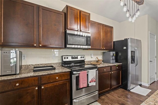 8553 Braylen Manor Dr, Douglasville, GA 30134 - kitchen with appliances with stainless steel finishes, dark wood finished floors, decorative backsplash, and dark brown cabinetry